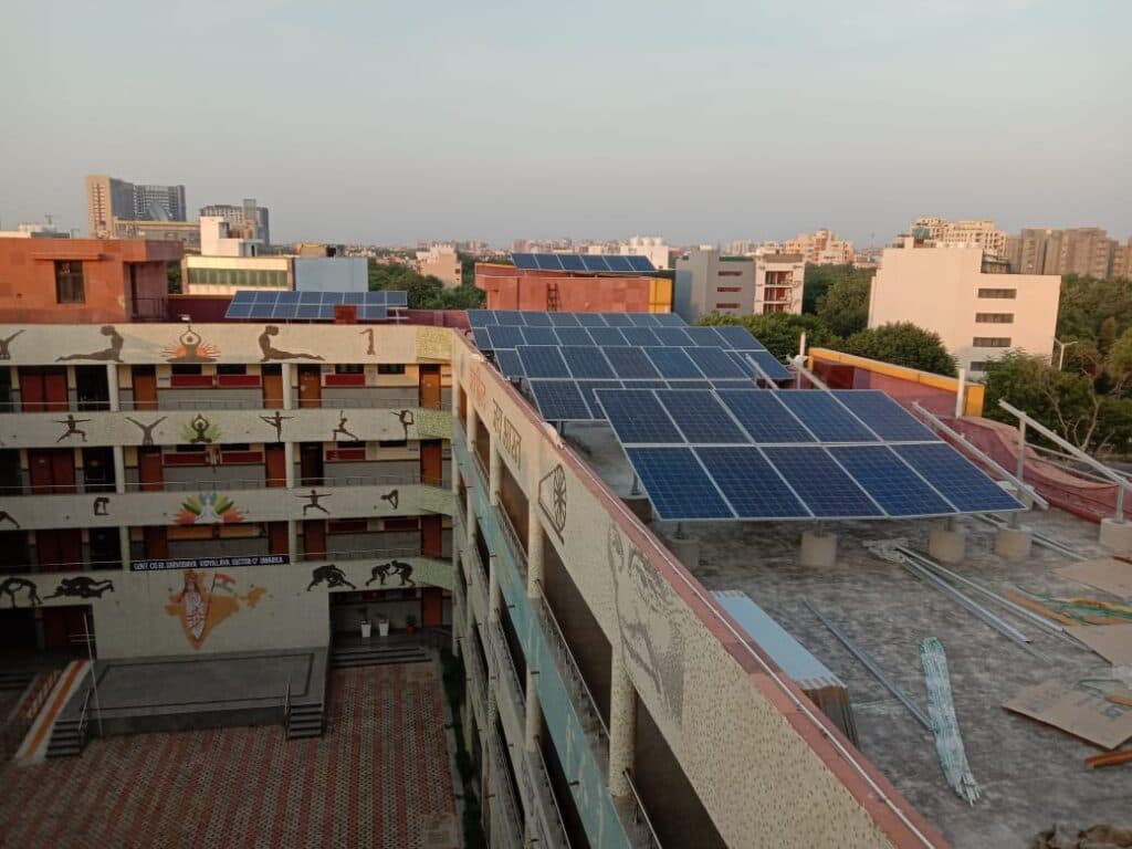 School building with solar panels and students learning